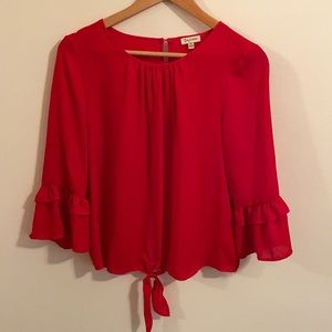 Red blouse with tie and layered ruffles sleeves